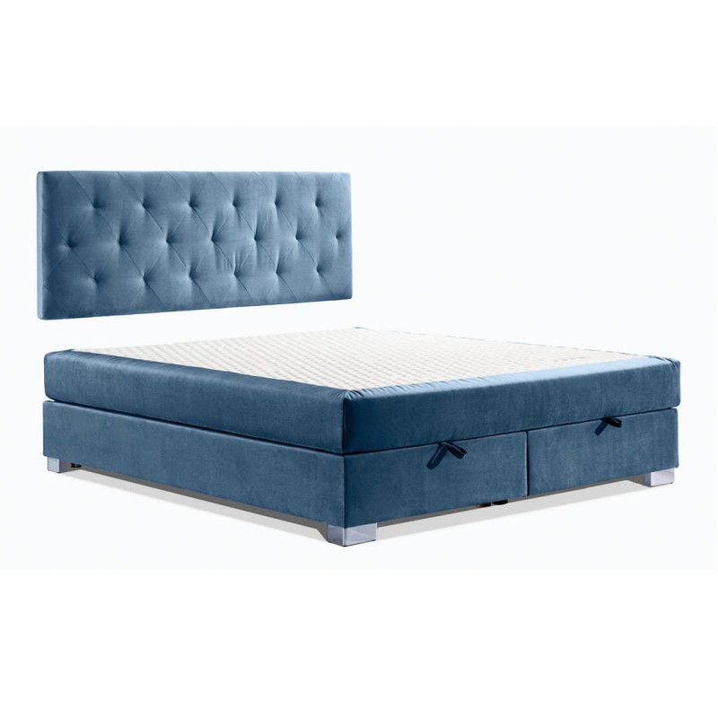 Łoże kontynentalne  z wezgłowiem wieszanym na ścianie pikowanym w foremne prostokąty. Ekonomiczne wymiarowo, nie zajmuje dodatkowego miejsca. Praktyczny pojemnik na stelażu elastycznym. Metalowa noga chromowana.